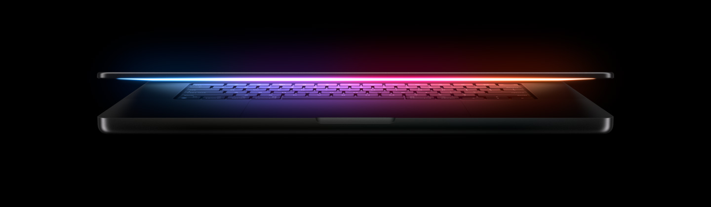 A MacBook glowing with a spectrum of light
